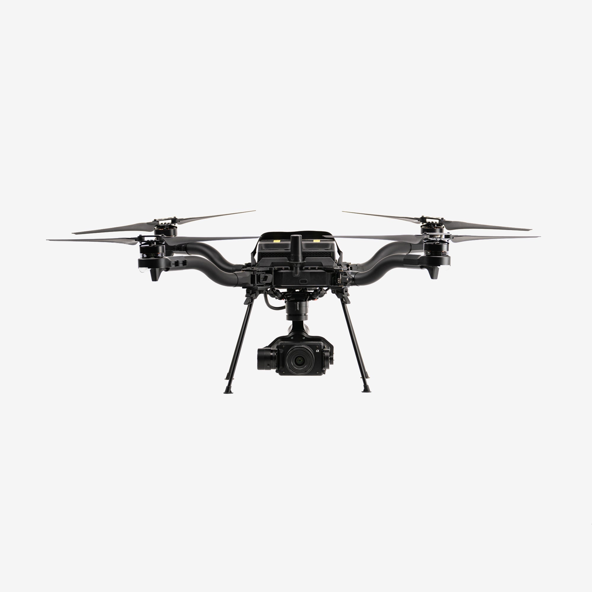 A black industrial drone with four rotors and a camera mounted on the front.